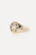 Signet ring with sapphires and diamonds in yellow gold on a white background