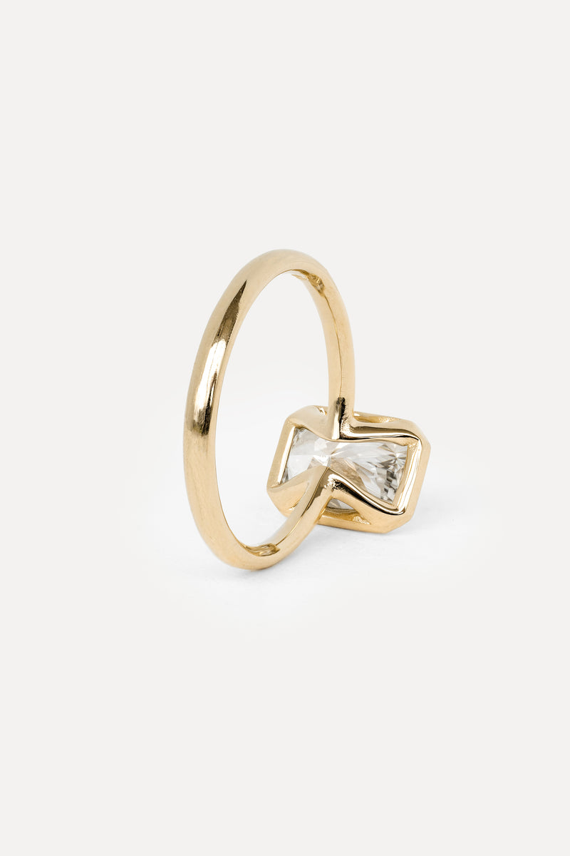 Gold ring with a diamond on a white background