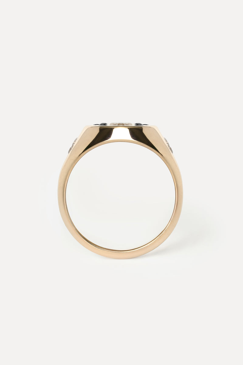 Profile of a yellow gold signet ring on a white background