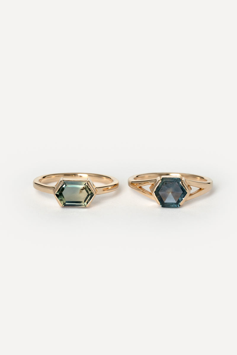 Two rings matching ring with blue hexagon Montana sapphires on a white background