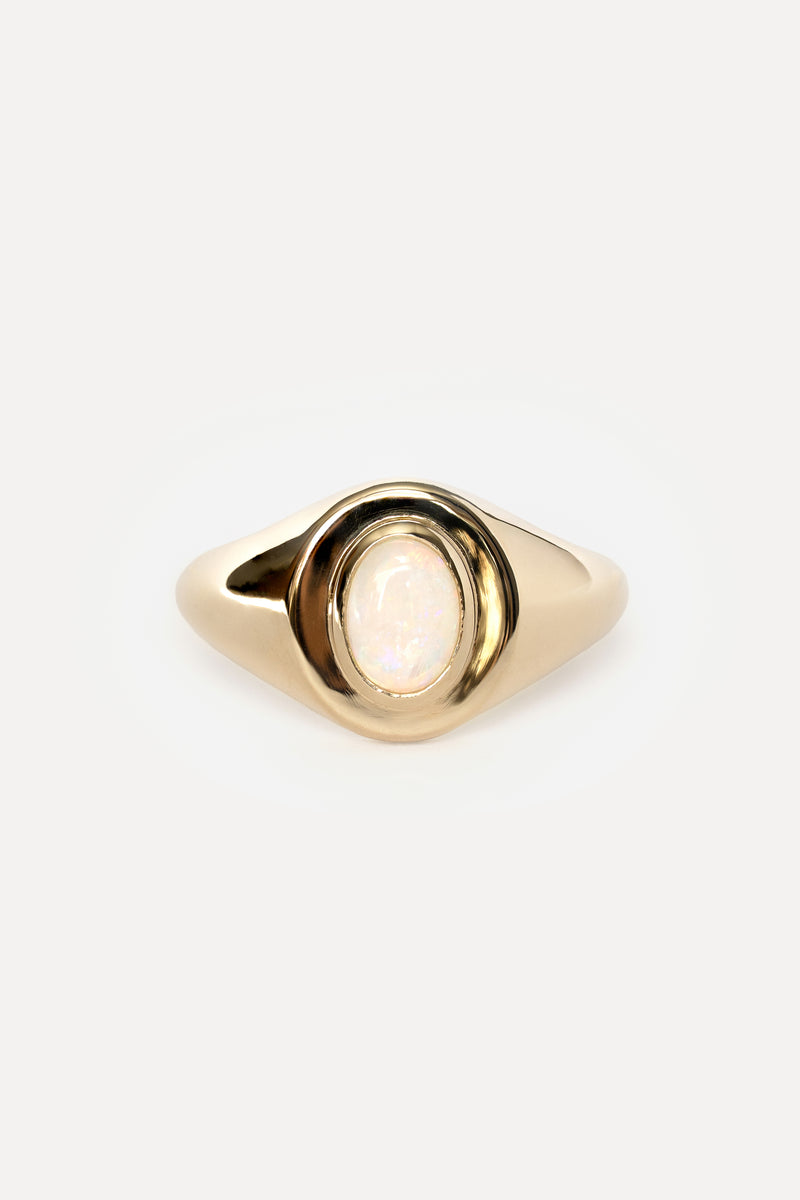Yellow gold signet ring with an oval bezel set opal