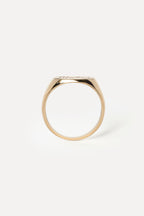 Profile of a yellow gold signet ring on a white background