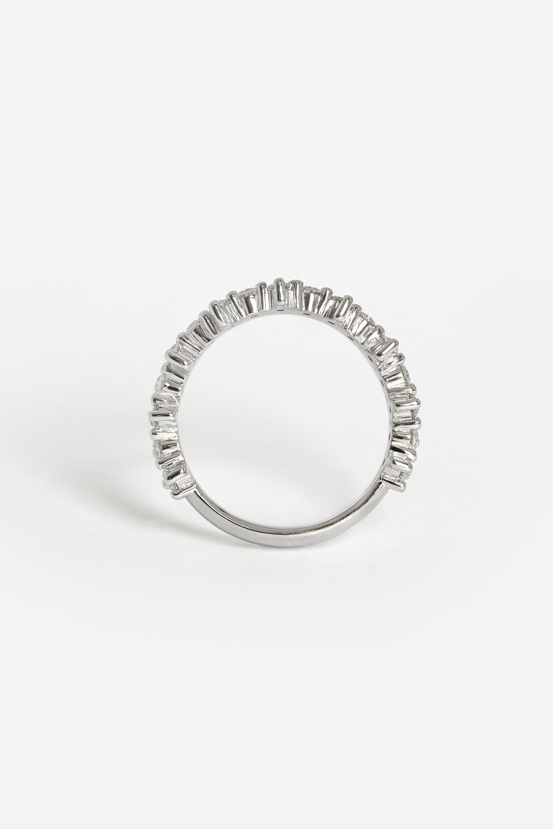 The side profile of a white gold ring featuring a prong settings, photographed on a clean white background.